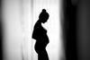 An image showing the silhouette of a pregnant woman