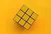 Yellow Rubik's cube on yellow background