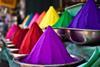 Piles of colored powders in an Indian market – holi colors
