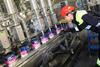 Paint tins being filled by machines at the AkzoNobel Ashington factory