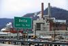 A photo of a sign for Belle in front of a chemical plant