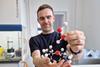 Scientist holding molecule