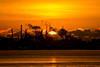 Sun rising over refinery