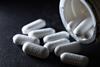 Paracetamol tablets against a dark background