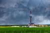Natural gas drilling worksite with dramatic sky
