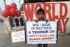 An Indian boy stands with a awareness placard during a HIV/ AIDs awareness program on the occasion of World AIDS Day on November 30, 2016 in Calcutta, India.