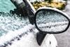Car door handle covered in snow