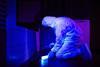 Technician collecting DNA evidence on place of crime under UV black light