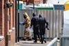 Emergency workers in protective suits search around John Baker House Sanctuary Supported Living