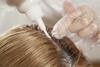 Close up image of hair dye being applied to blonde hair