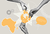 Hands building a lightbulb puzzle with the Africa map next to it