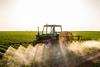 Tractor spraying soybeans