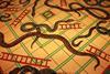 A photo of a vintage snake and ladders board