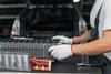 Serviceman repairs electric battery pack of hybrid car