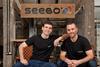 Liran and Lior Akavia seated in front of a Seebo sign