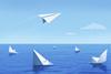 Paper boats sinking while paper plane flies off