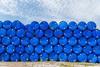 Plastic blue chemical barrels stacked up
