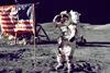 An astronaut on the moon saluting an American flag