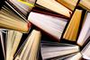 Photograph of many hardback books, stood on end and viewed from above