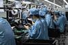 Working assembling mobile phones in a Chinese factory.