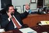 Dr. Ahmed Zewail talking on the phone in his office
