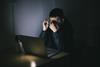 Man using laptop at night