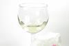 Lipstick marks on a tissue next to a wine glass