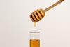 Honey dripping into a test tube