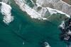 Ocean waves along the shoreline from an overhead view