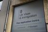 An office building with a sign for UK Visas & Immigration application centre