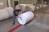Man marking roll of printing paper