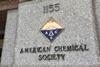 A sign and a crest on a marble building for the American Chemical Society