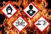 Globally Harmonized System of Classification and Labelling of Chemicals (GHS) pictograms for chlorine trifluoride on a background of flames