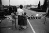 Woman holding children in front of barrier of Zone A during Seveso disaster