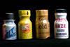 A photo of four small poppers bottles. Their colourful plastic wrappers advertise them as room odourisers or aroma with brand names such as Liquid Gold, Bolt and Purple Haze
