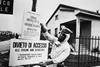 An official in protective clothing places warning signs following the Seveso disaster in 1976
