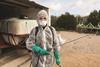 image shows female pesticide worker in PPE