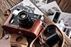 Vintage camera and photos on a wooden table