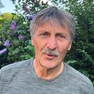 Rudy Dams headshot in a garden