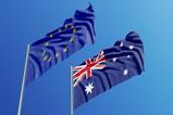 An Australian and an EU flag blowing in the wind