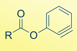 A chemical structure of a carbon with an R Group a double bonded oxgygen and a single bonded oxygen attached to an aromatic ring which contains a triple bond