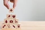 Stacking wooden blocks printed with healthcare-related icons