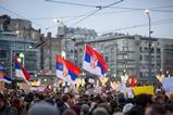 Citizens protesting in Serbia waving national flags