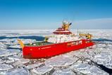 The RRS Sir David Attenborough with its bright red hull sailing through broken ice