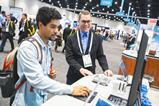 Two attendees at the Pittcon conference working around around a computer