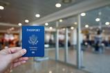 Someone holding an American passport at an airport