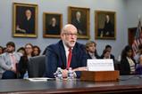 The Honorable Russell Vought, Director of the Office of Management and Budget speaks in front of a committee. Behind him is an audience with old portrait on the wall.