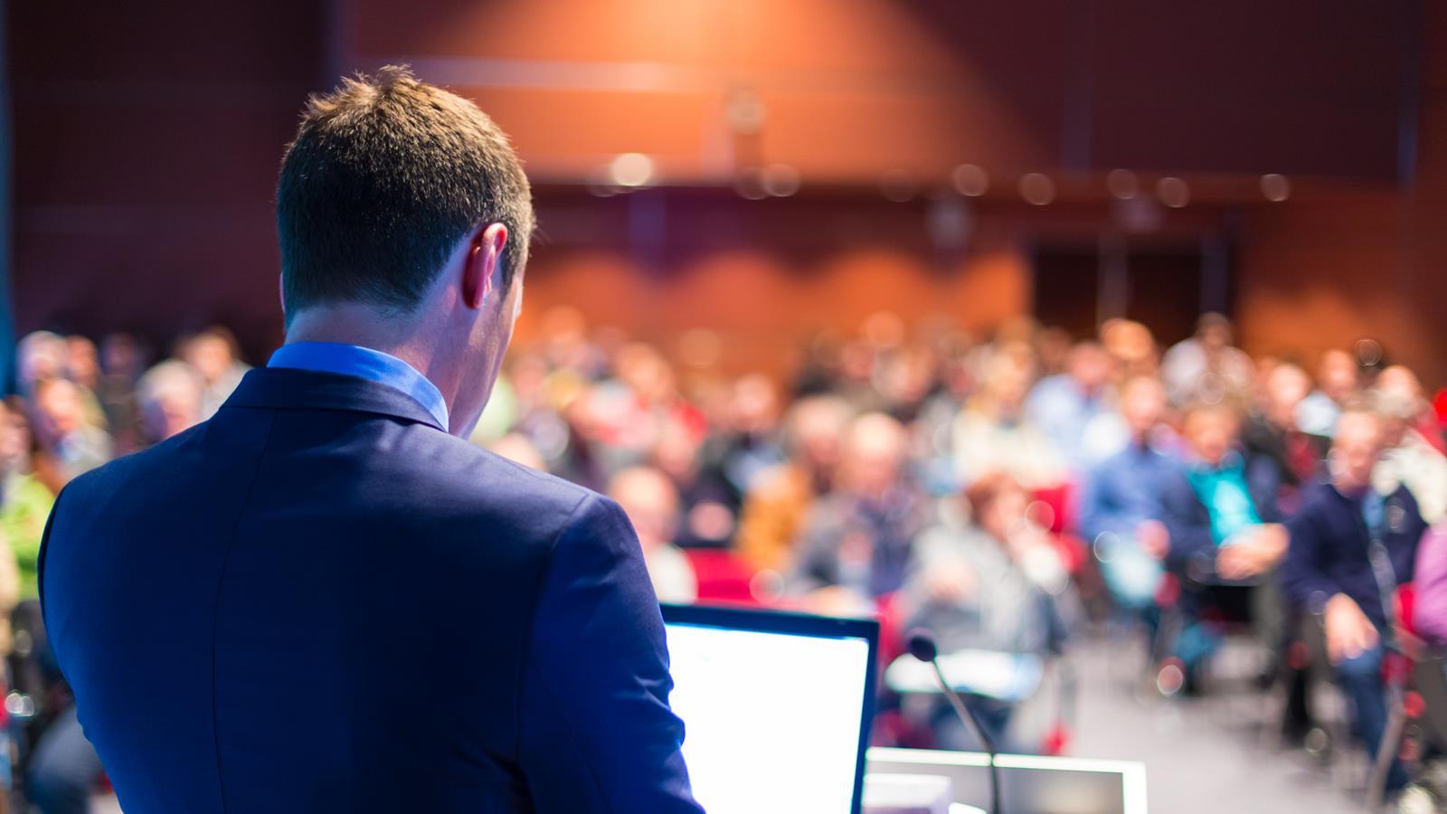 Man giving presentation to large audience
