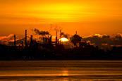 Sun rising over refinery