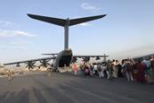 People queuing to board a military plane